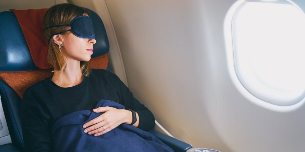 nő alszik a repülőn